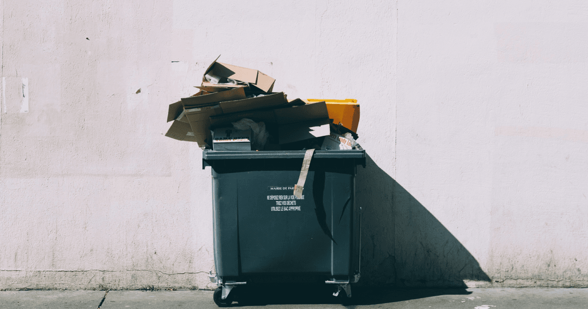 Lots of full recycling bags packed in together.